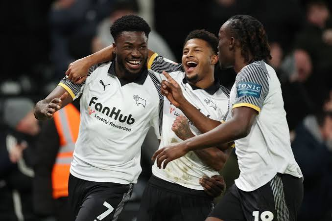 Derby County players celebrating in FanHub-sponsored shirts